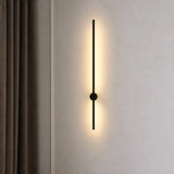 Vertical black linear LED wall light beside a soft beige curtain