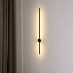 Vertical black linear LED wall light beside a soft beige curtain