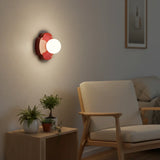 Grouped colours of the orb wall sconce shown together on a plain backdrop