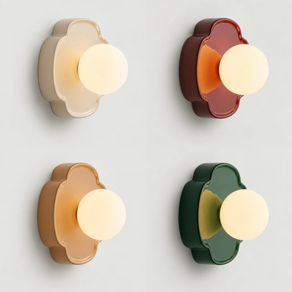 Green flower-shaped orb wall sconce with frosted glass globe on white