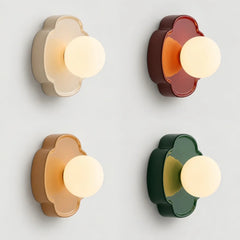 Green flower-shaped orb wall sconce with frosted glass globe on white