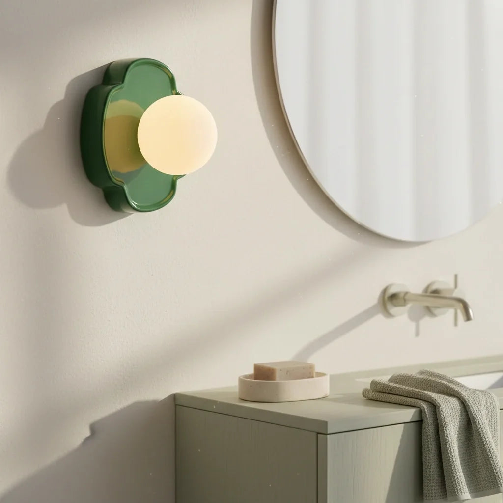 Red orb wall sconce three-quarter view highlighting the petal backplate