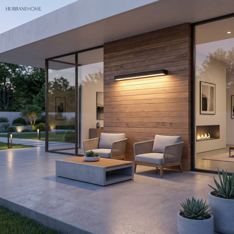 Slim black linear wall light mounted on a textured concrete exterior wall