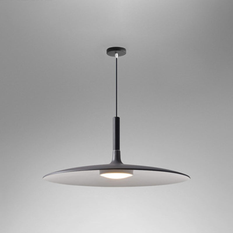 Black saucer pendant shade shown lit on a grey background