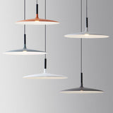 Four saucer pendants in orange, white and grey hung at heights