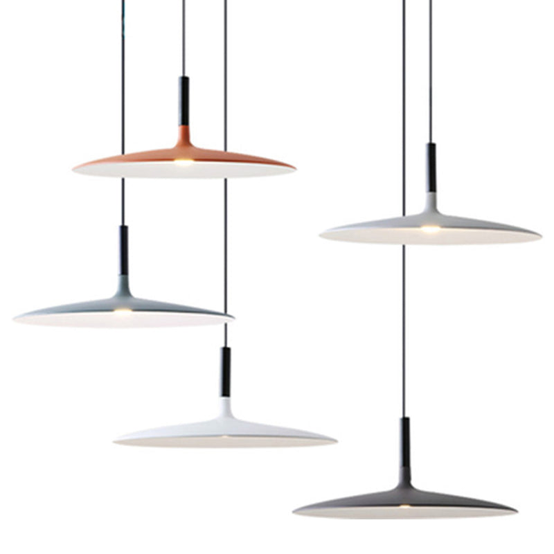 Four saucer pendants in mixed colors hung together on white