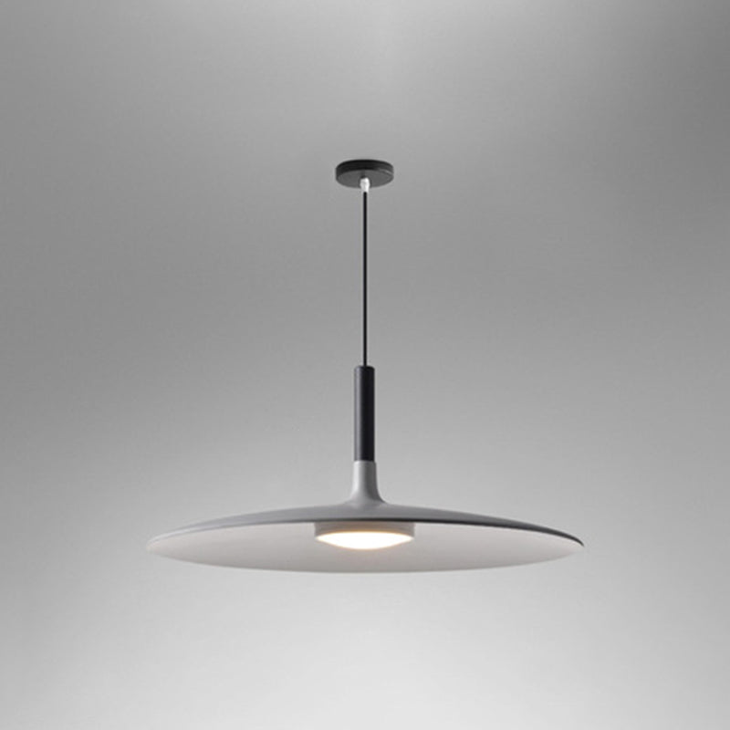 Grey saucer pendant shade shown at a low angle on grey