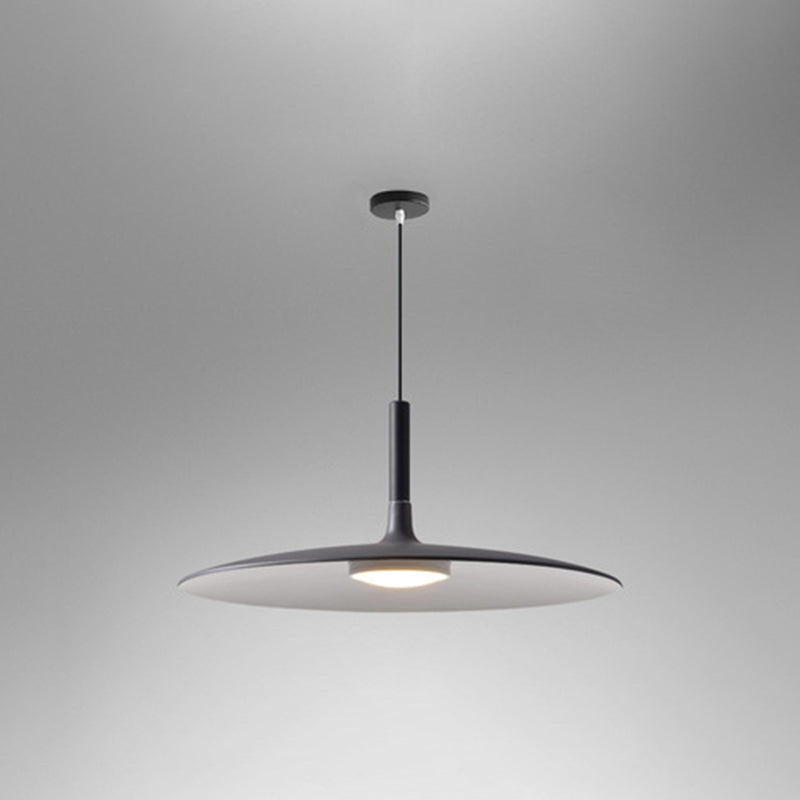 Grey saucer pendant shade shown lit on a grey background