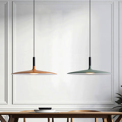 Orange and green saucer pendants lit above a timber table