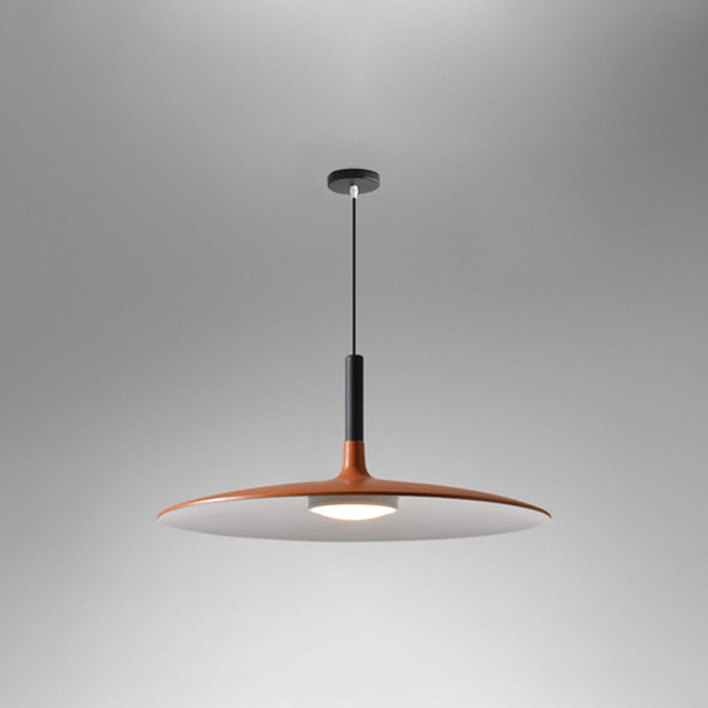 Orange saucer pendant shade shown at an angle on grey