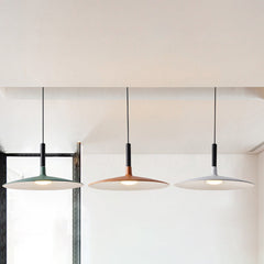 Green, orange and white saucer pendants hanging by a window