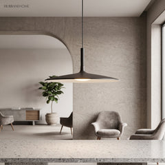 White saucer pendant lit in a pale living room with an archway