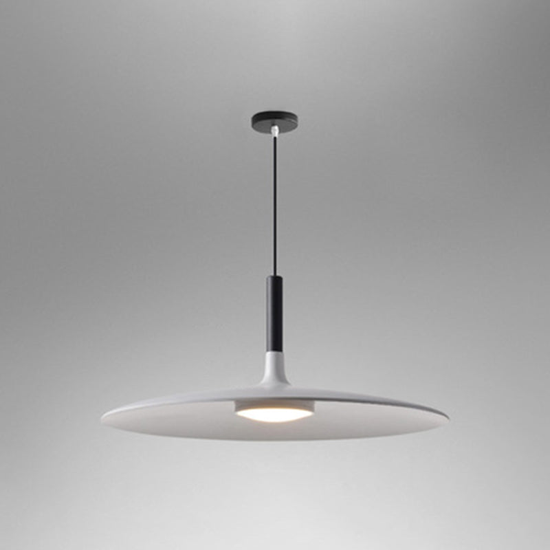 White saucer pendant shade shown lit on a grey background