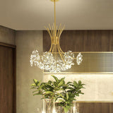 Gold dandelion chandelier in a dining room with a leafy indoor plant
