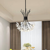 Black dandelion chandelier in a dining room with soft beige curtains