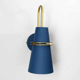 Blue cone sconce seen at an angle showing the brass ring band