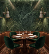 White cone sconces mounted on a green marble restaurant wall