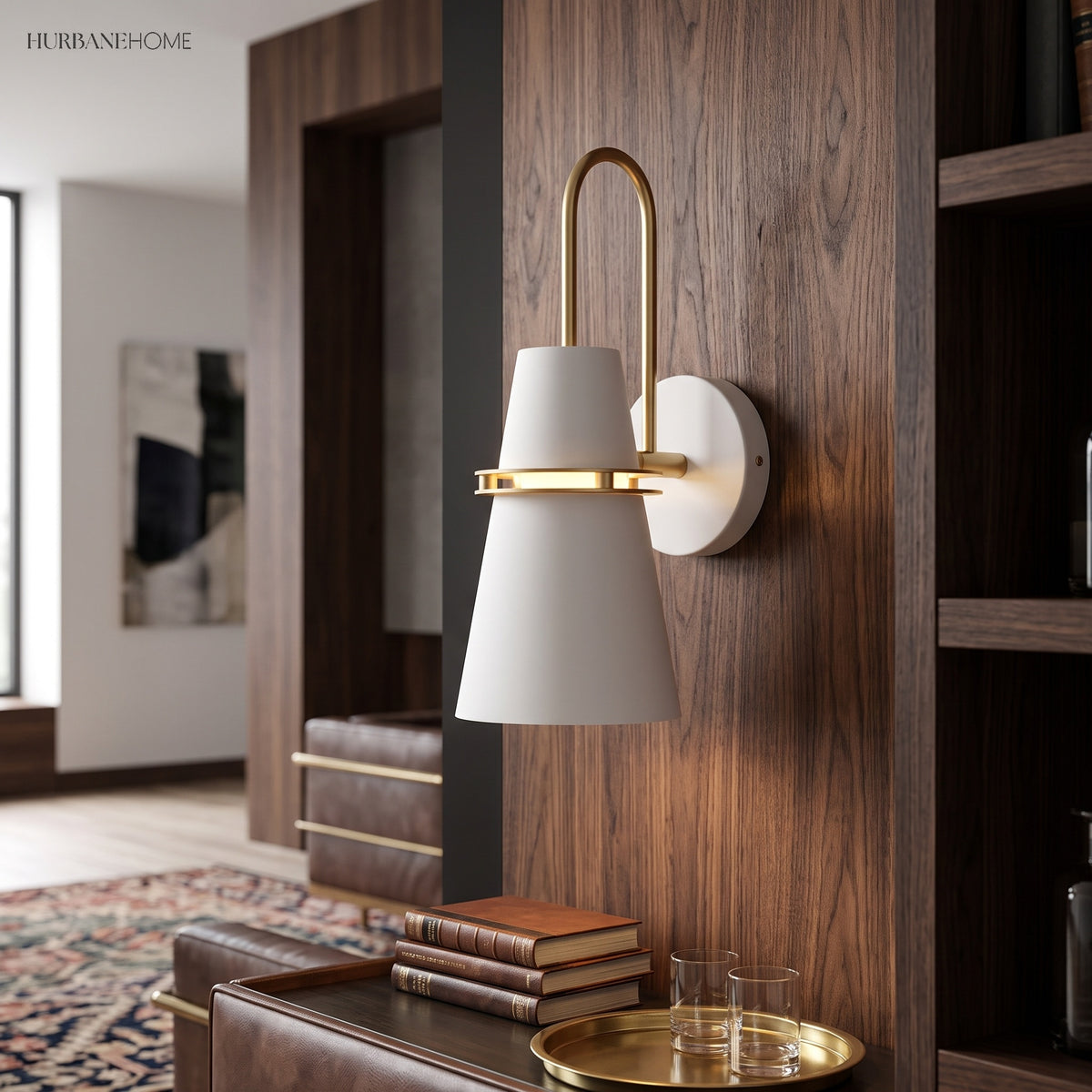 White cone sconce with a brass hook arm on a walnut wall