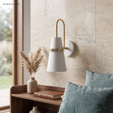 White cone sconce lit beside a window and a stone effect wall