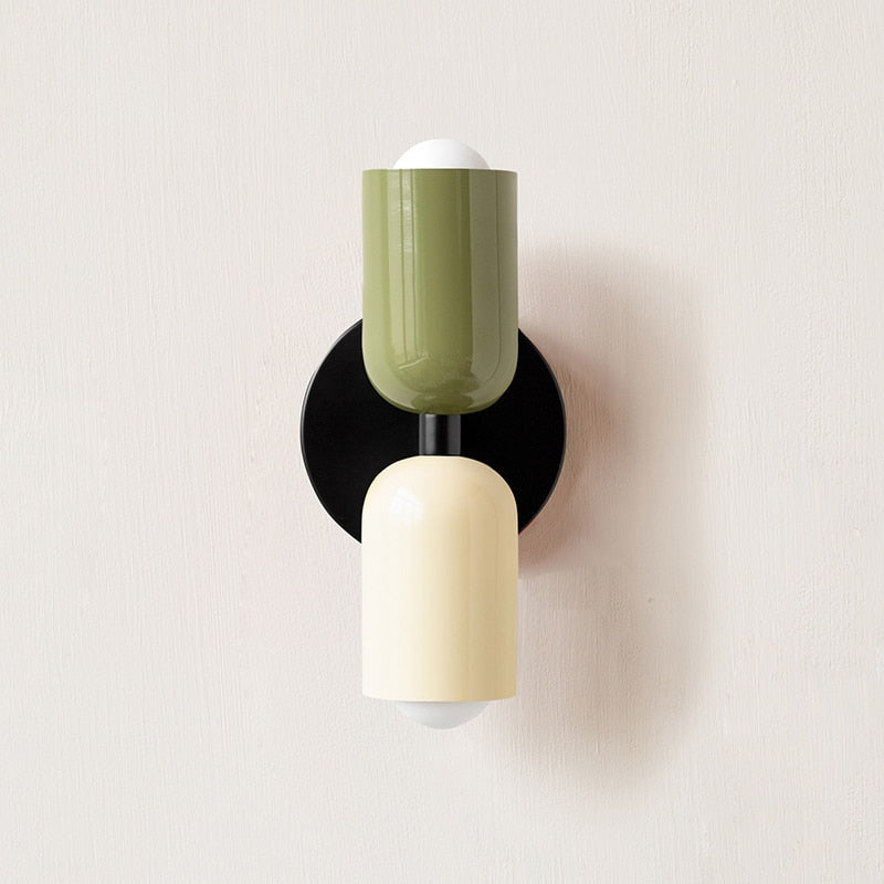 Olive and cream cylinders mounted on a black round backplate