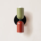 Olive and olive cylinders on a black round backplate