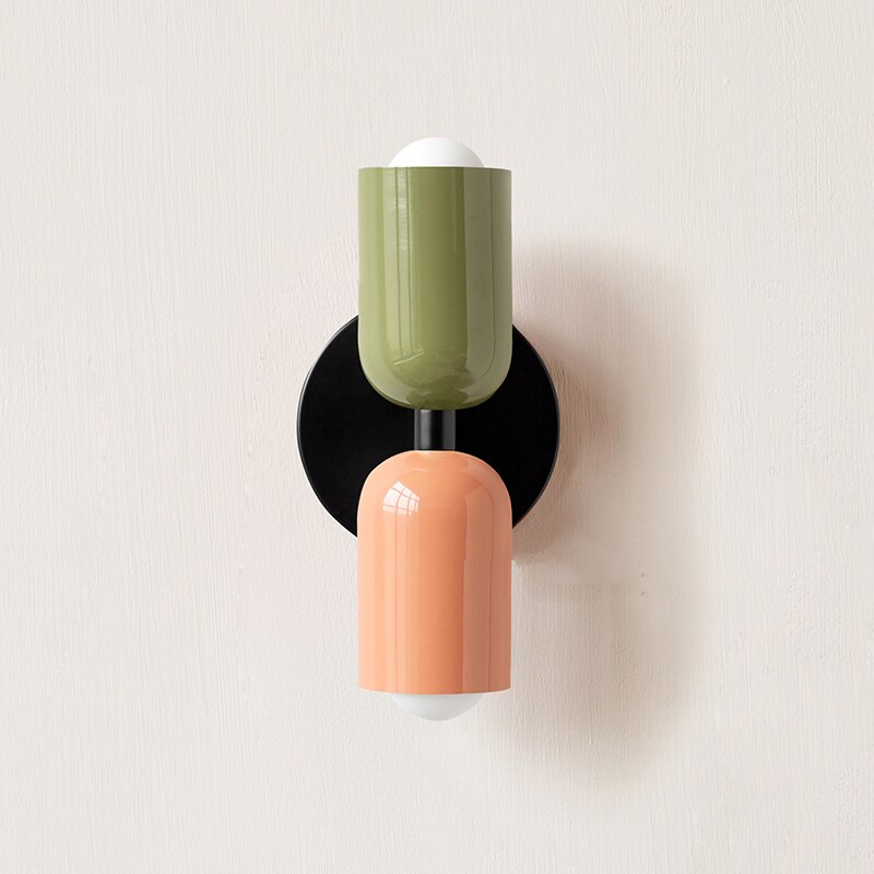 Olive and terracotta cylinders on a black round backplate