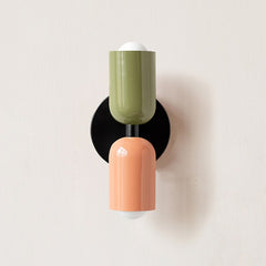 Olive and terracotta cylinders on a black round backplate