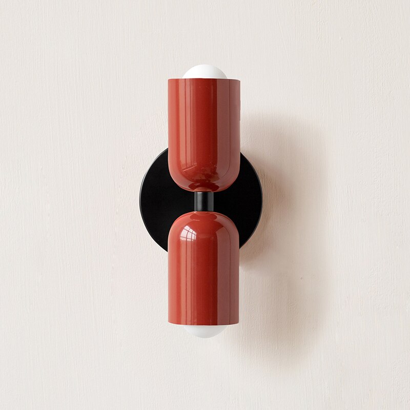 Terracotta and dark red cylinders on a black round backplate