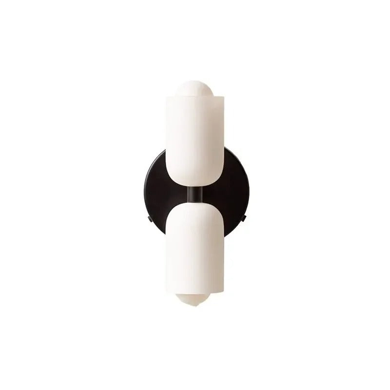 Two white cylinders on a black backplate without a cord