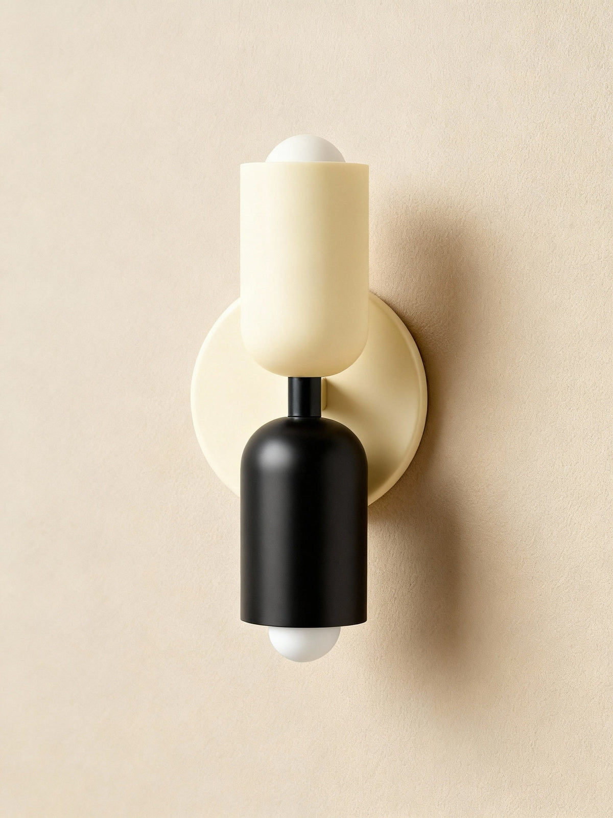 Cream top and black base cylinders on a cream backplate