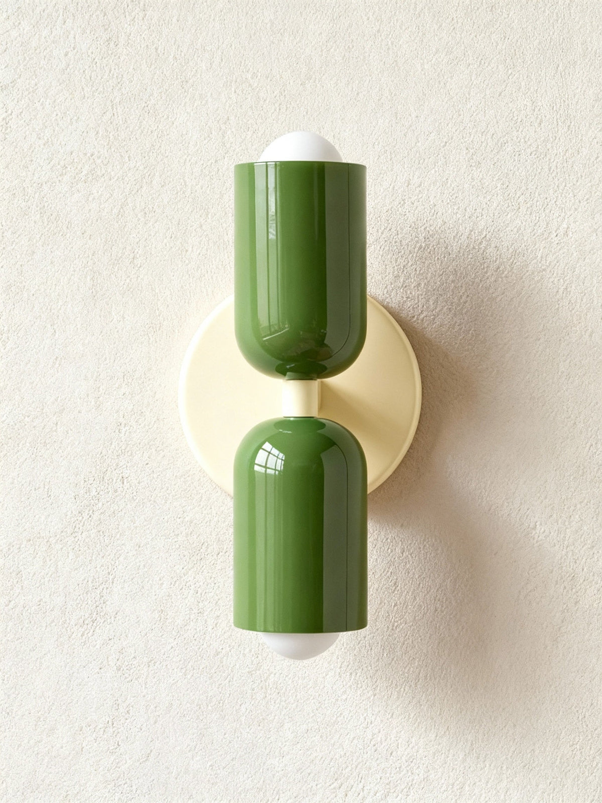 Two olive green cylinders mounted on a cream round backplate