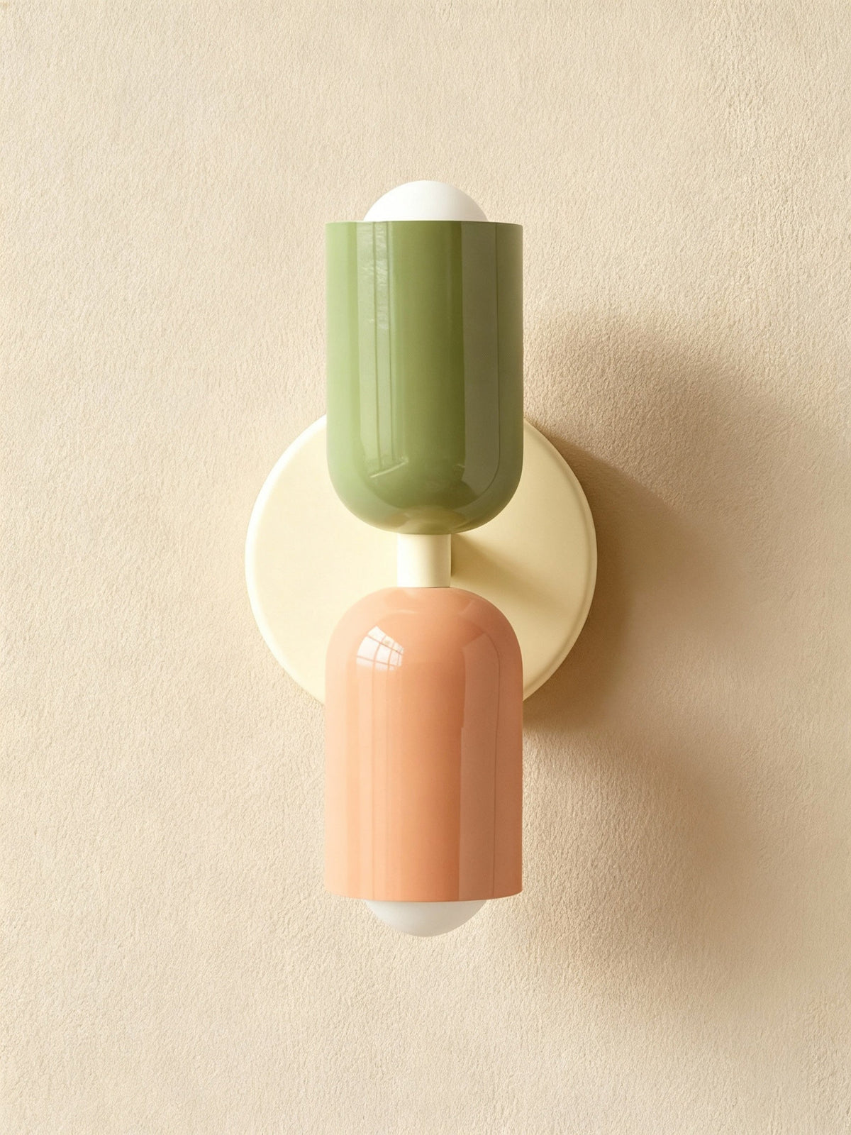 Olive and terracotta cylinders on a cream round backplate