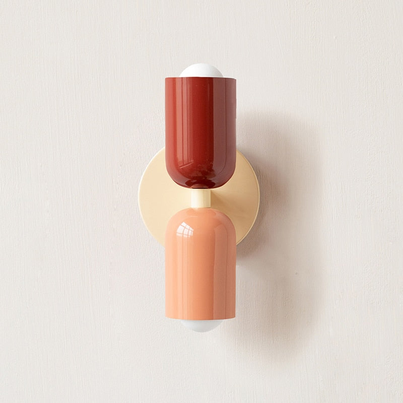 Dark red and terracotta cylinders on a cream round backplate