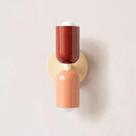 Dark red and terracotta cylinders on a cream round backplate