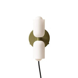 White cylinders on an olive gold backplate with a trailing cord