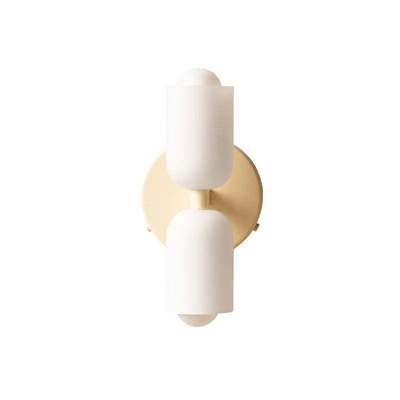 Two white cylinders mounted on a warm gold round backplate