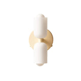 Two white cylinders mounted on a warm gold round backplate