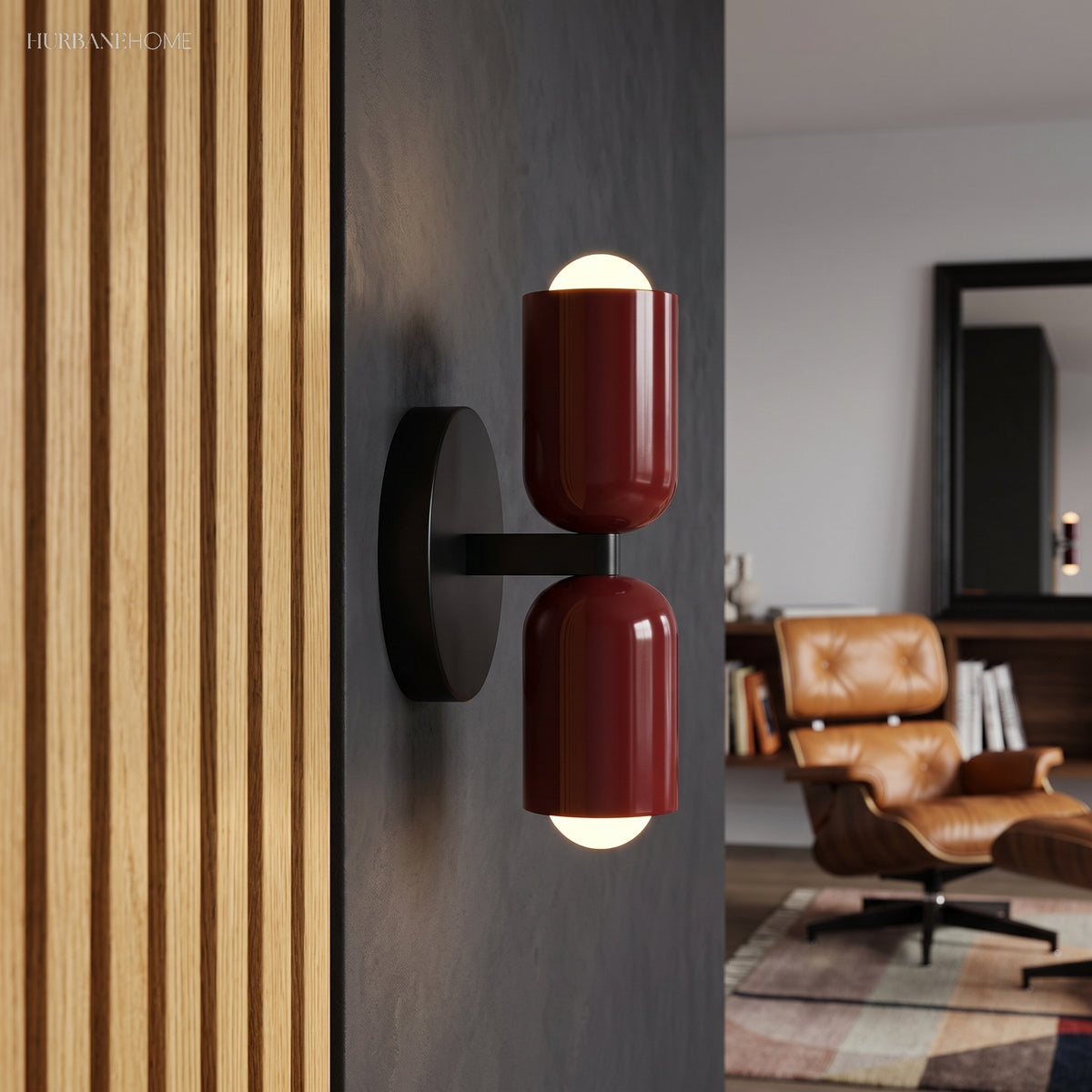 Two red cylinder sconces lit on a dark wall beside timber slats