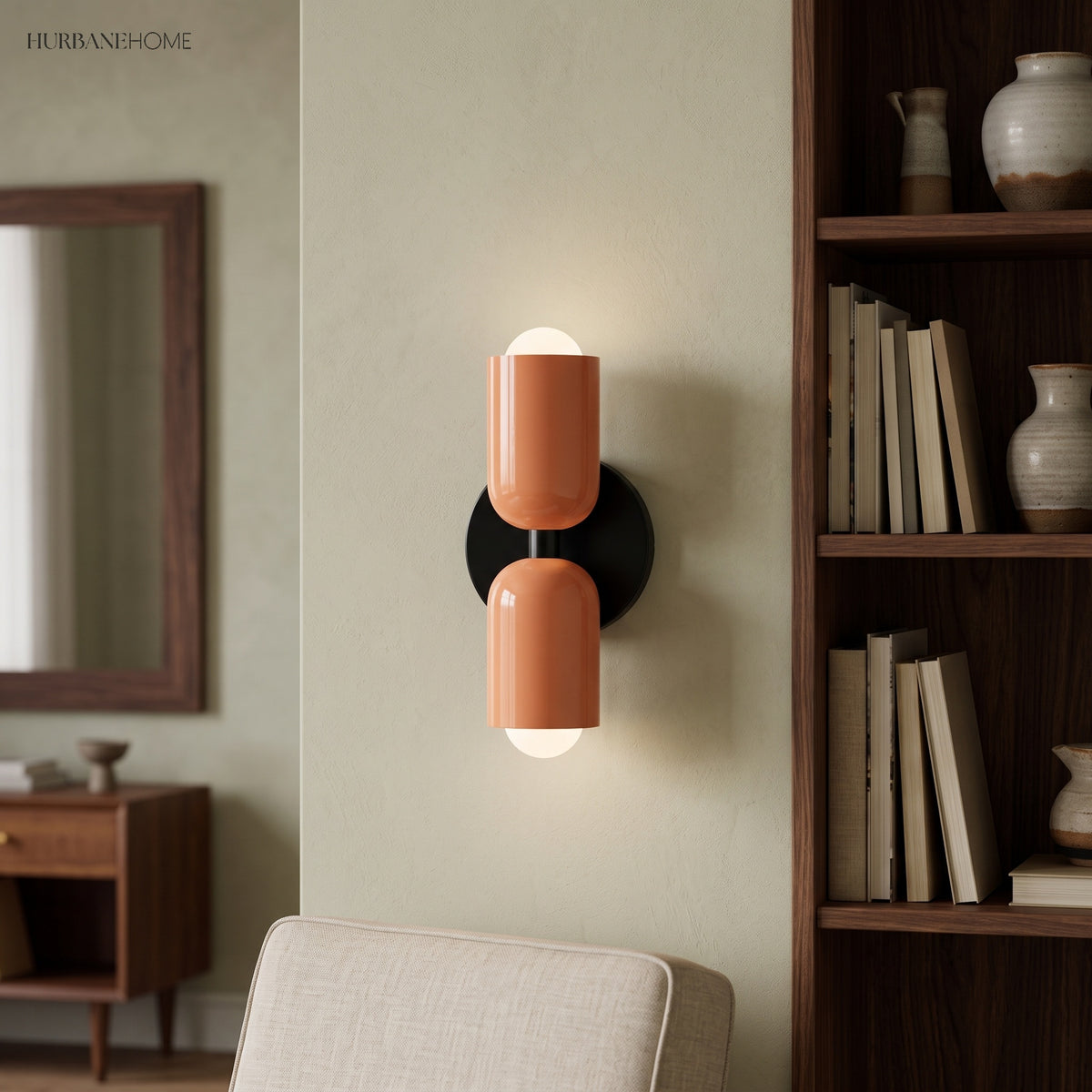 Terracotta and cream sconce lit beside a mirror and wooden shelving