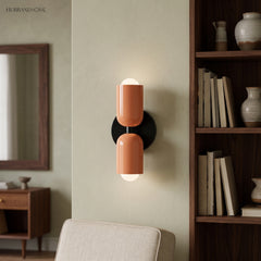 Terracotta and cream sconce lit beside a mirror and wooden shelving