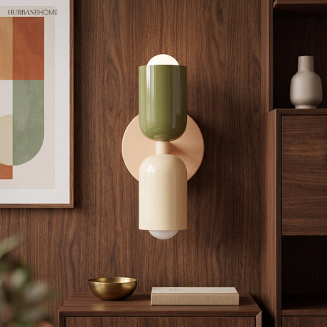 Olive and cream sconce lit on walnut panelling above a sideboard