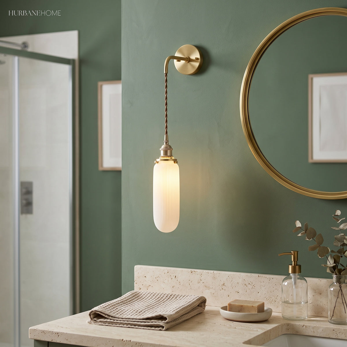 Capsule shade sconce on a cord beside a round bathroom mirror