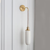 Slim capsule white shade hanging on a braided cord, shown unlit
