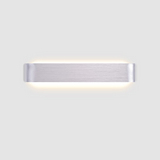 Silver linear wall sconce photographed alone on a grey ground