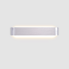 Silver linear wall sconce photographed alone on a grey ground