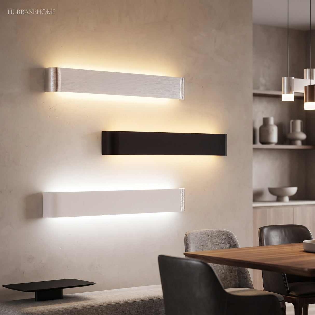 Three linear wall sconces in silver black and white on a wall