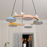 Modern wood chandelier with white bird figures resting on the round timber ring