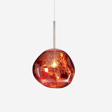 Studio shot of the lit copper molten pendant shade on a plain pale background