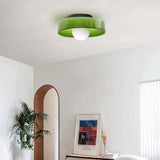Green glass disc ceiling light on a ceiling
