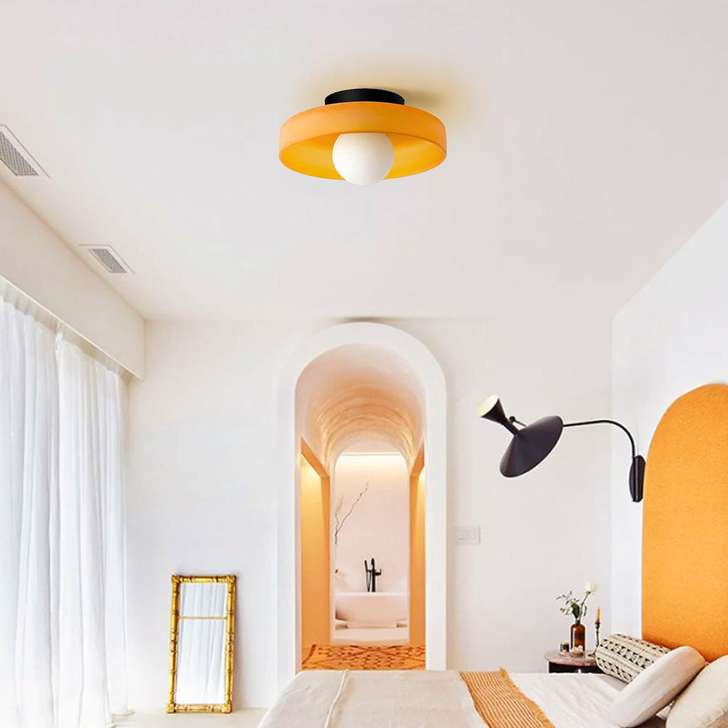 Orange-toned glass disc ceiling light